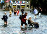 AP Una mujer empuja una silla de ruedas a través de las calles de Lucerna (Suiza) anegadas por las inundaciones