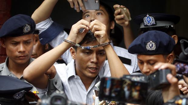 El periodista birmano de Reuters Kyaw Soe Oo es escoltado por agentes hacia el tribunal