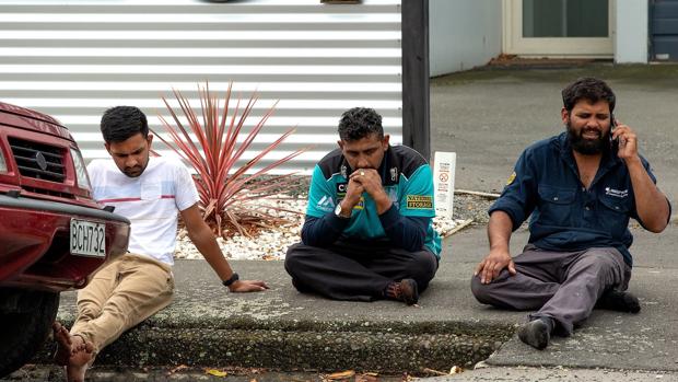 Personas se sientan en una acera tras el atentado en Masjid Al Noor , en Christchurch (Nueva Zelanda)
