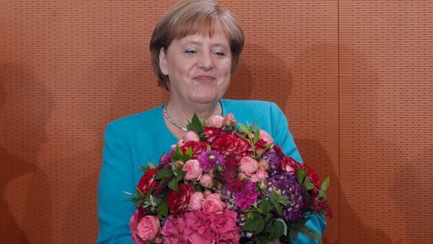 La canciller alemana, Ãngel Merkel, tras recibir un ramo de flores de su gabinete esta maÃ±ana
