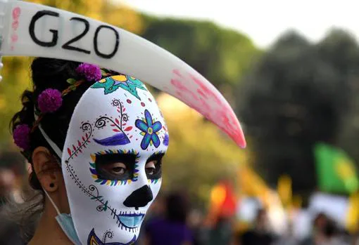 A woman protests in Rome against the G20 summit